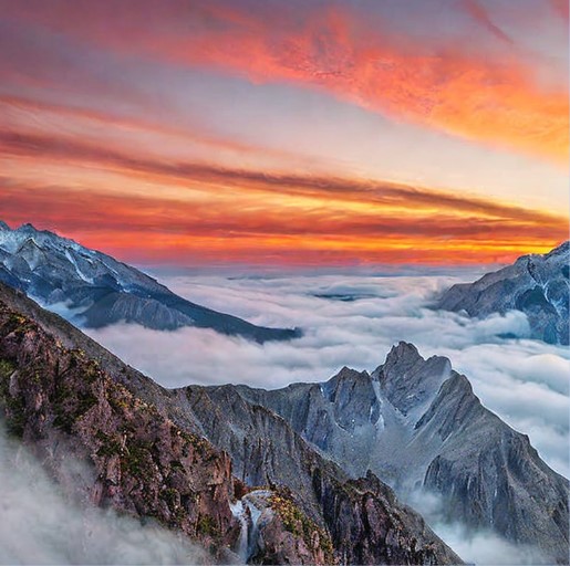 Lonely peak, peeks above clouds, sunrise paints it golden pink. Misty valleys below, waterfall sings, magic feels close. Picture-perfect view, soft colors, like a dreamy painting.